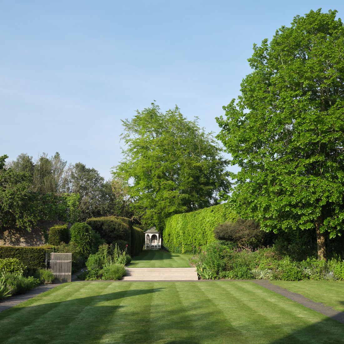 A formal flight of steps connect terraced lawns