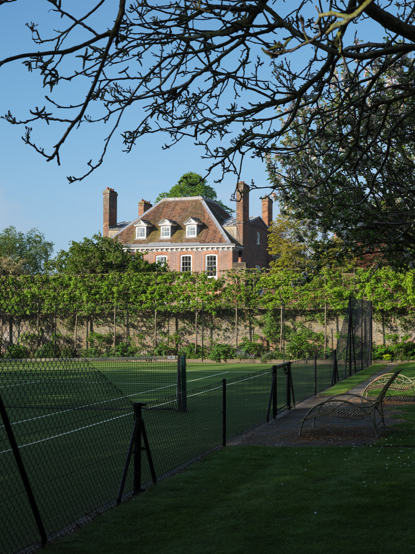 Pleached pear trees veil the court