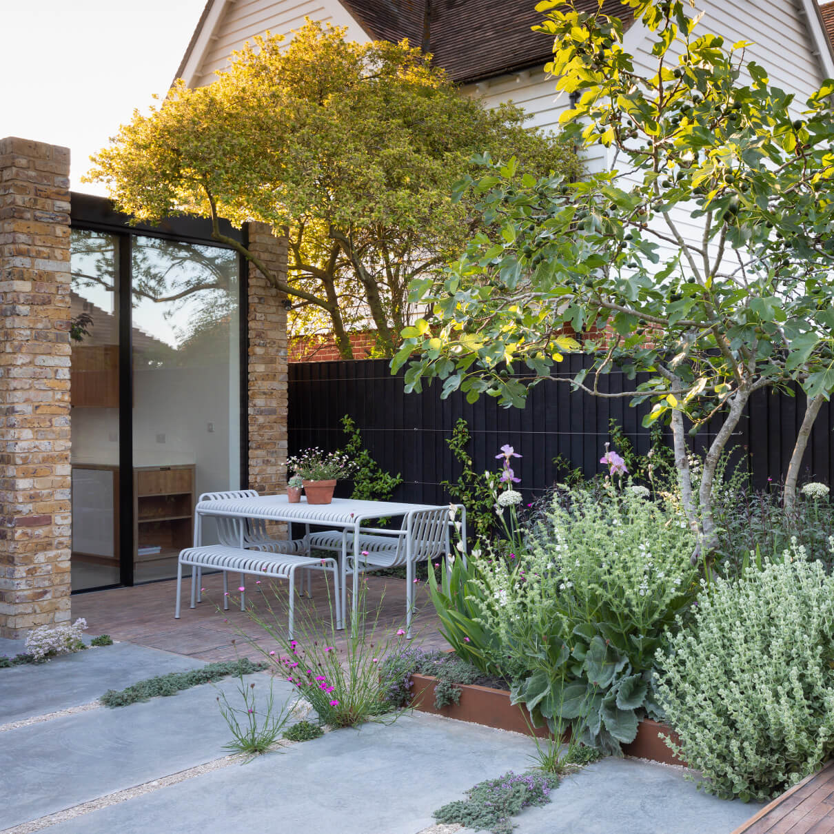 Drought tolerant planting surrounds a dining terrace