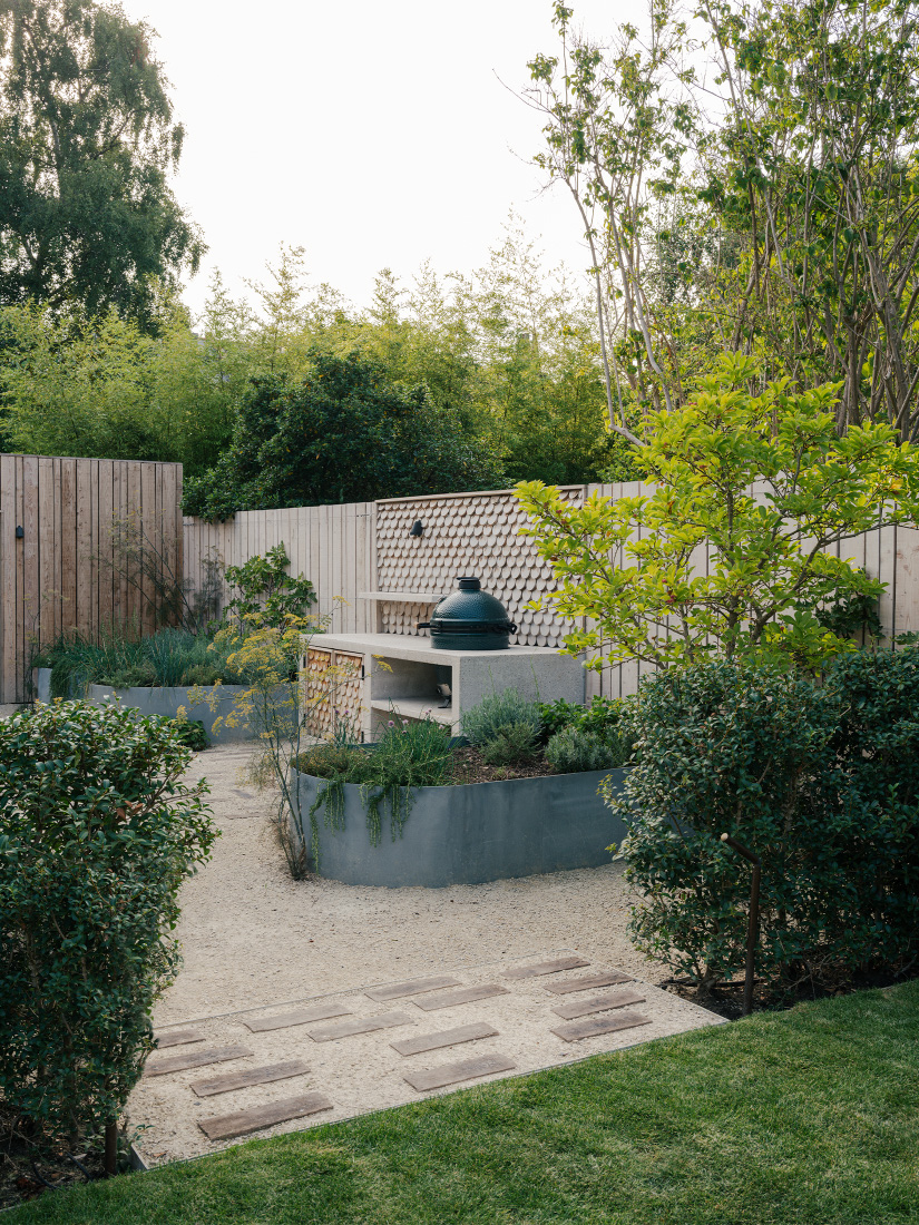 Elevated herbs envelop the outdoor kitchen